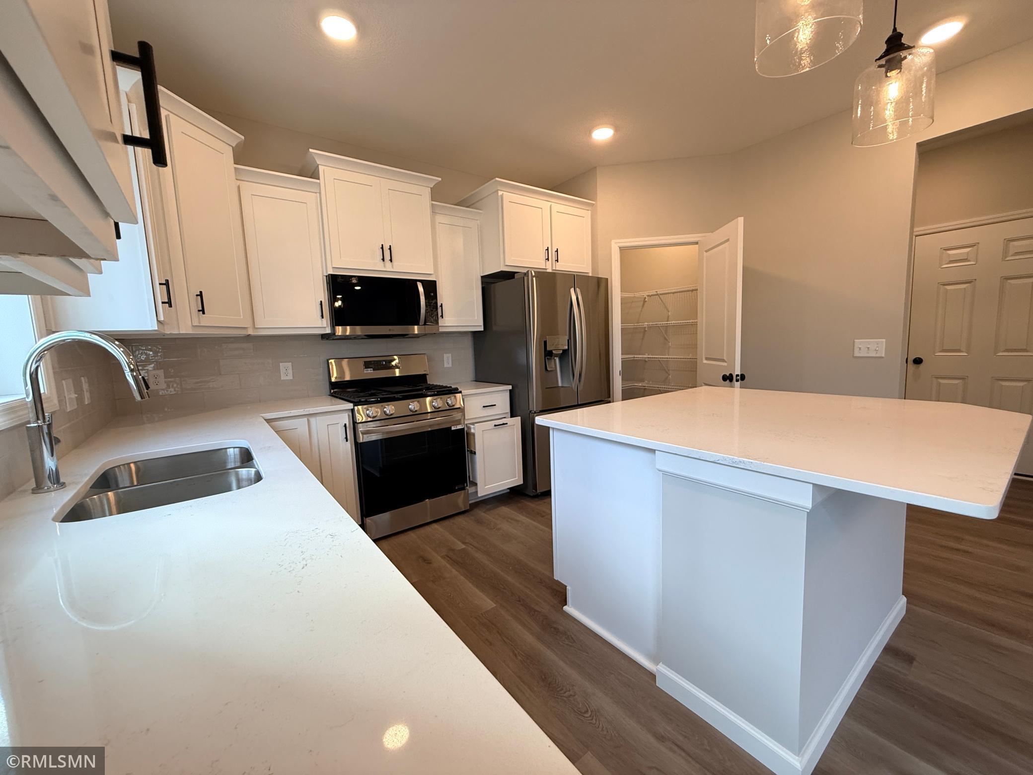 This kitchen view shows the huge walk-in pantry - organize all your pantry items and small appliances and more
