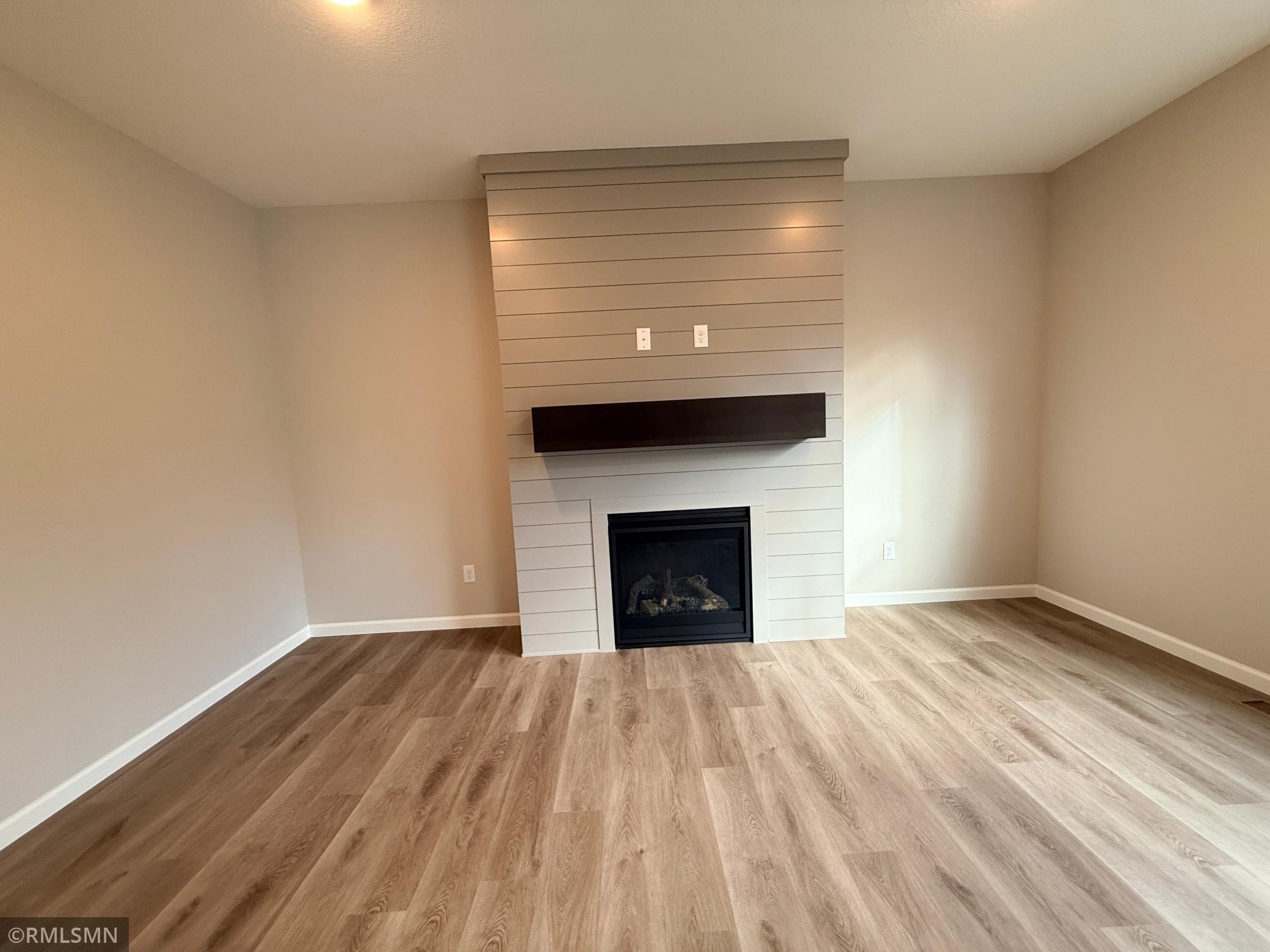 This home features TWO fireplaces - this shiplap gas fireplace is so classy and homey!