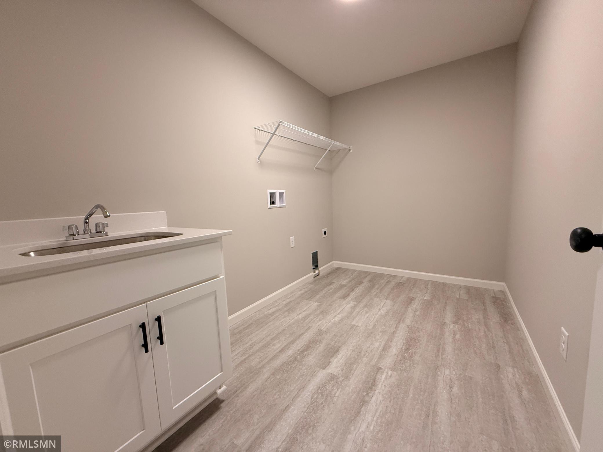 The oversized laundry room has plenty of space for everything you need whether it's neat stacks of clean clothes or mounds of dirty clothes