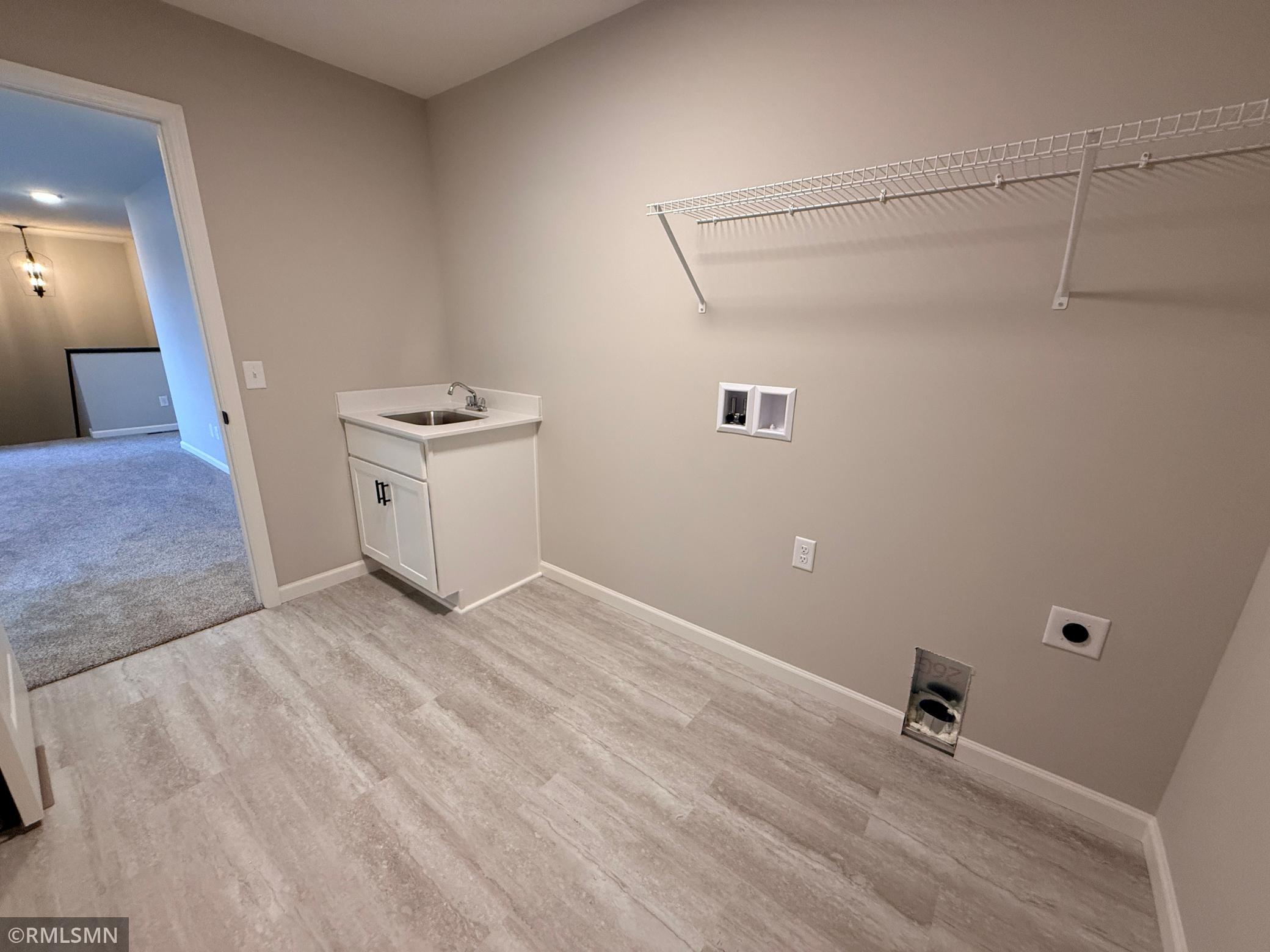 The oversized laundry room has plenty of space for everything you need whether it's neat stacks of clean clothes or mounds of dirty clothes