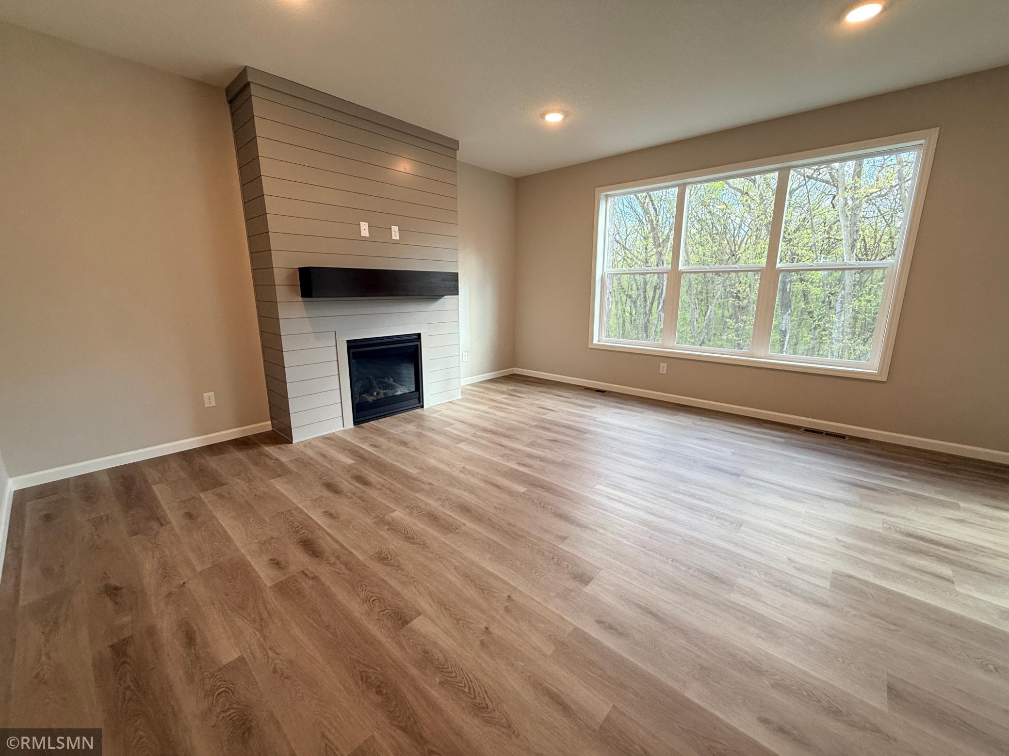 Enjoy the cozy ambience of this beautiful fireplace while enjoying the peaceful backyard view