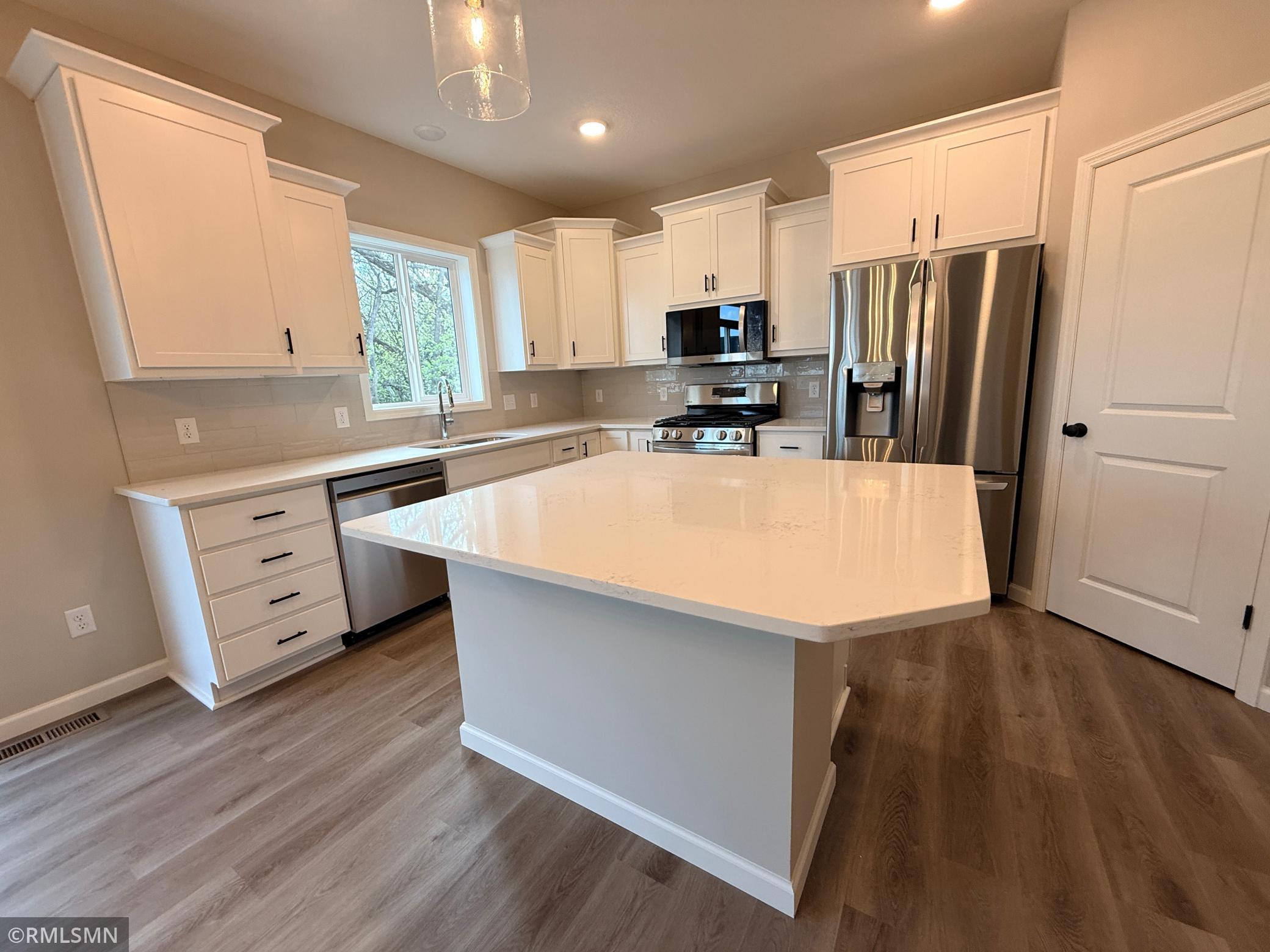 Cooking is a breeze in this open airy space featuring numerous storage options and large working surfaces