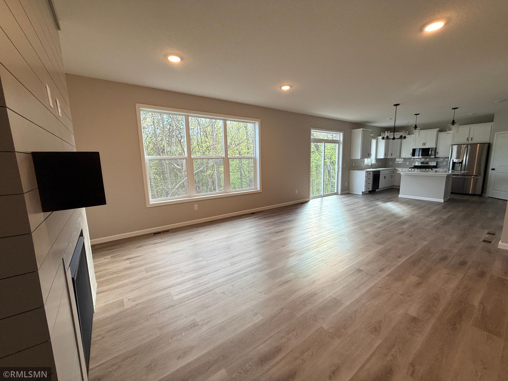 The luxury plank flooring throughout makes room arrangement easy and quickly changeable to accommodate gatherings of many sizes.