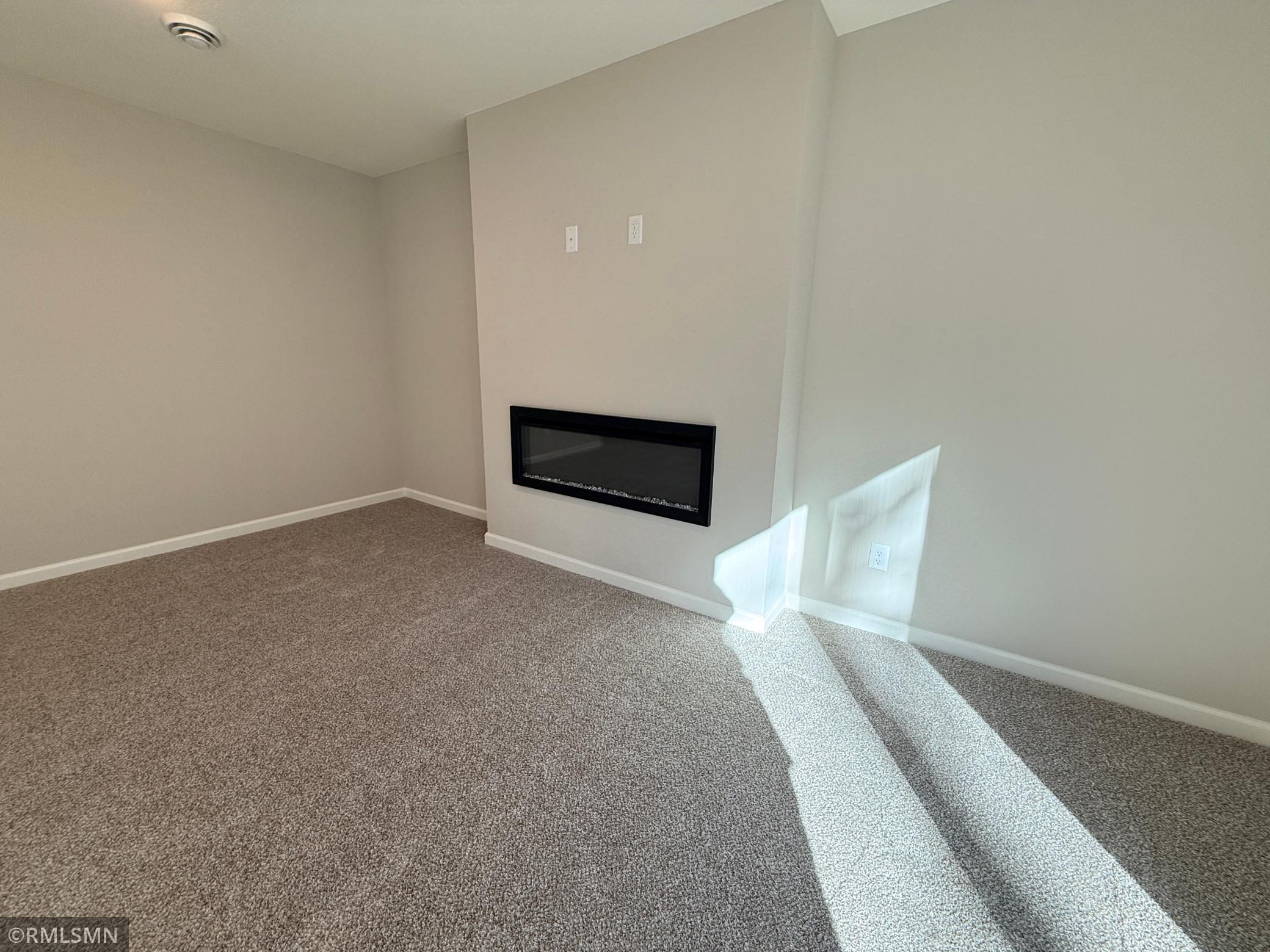 This huge family room features a sleek electric fireplace and walkout sliding doors leading to your treed backyard area.