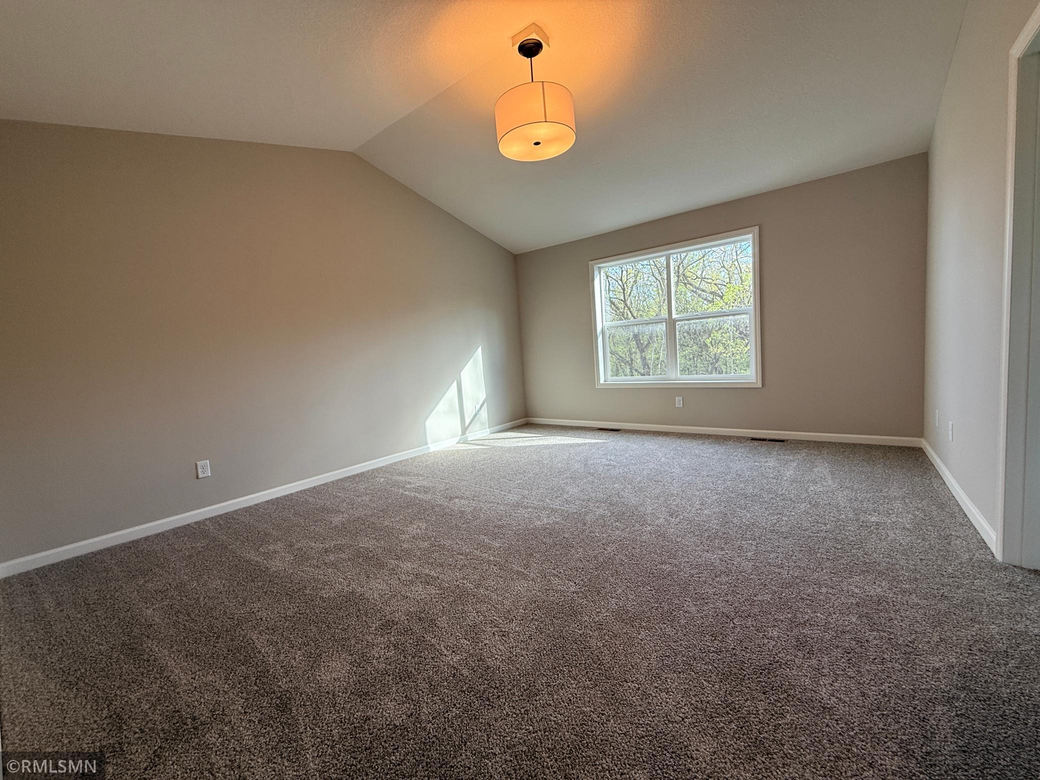 The owner's suite bedroom is extra large and the vaulted ceiling adds more luxury