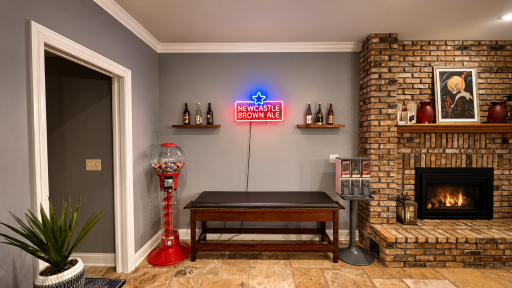 8140 134th St W - Game room with floating shelves, expansive travertine tiled floors, this is the entry to the movie theater..