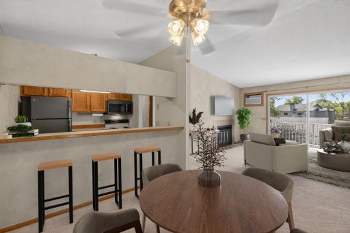 Open-concept layout connecting kitchen, dining, and living spaces. Virtually staged.