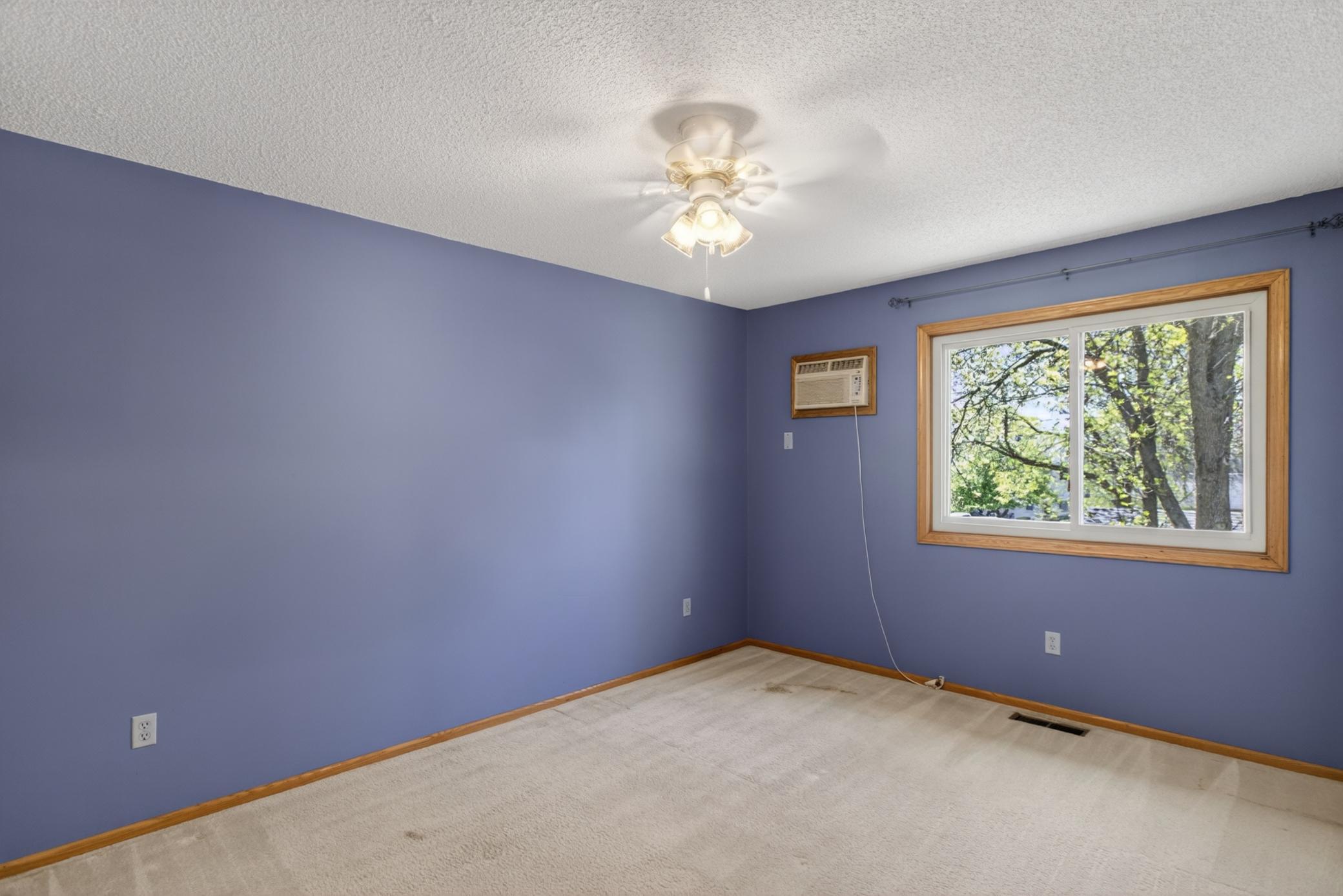 Primary bedroom with large window and natural light