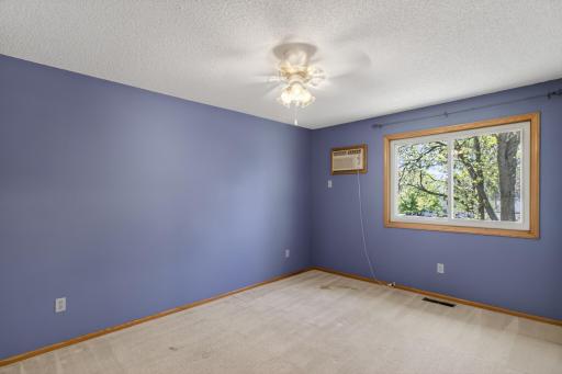 Primary bedroom with large window and natural light