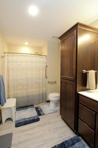 The full bathroom located off the hallway has ample room for accessibility needs and has grab bars already in place.