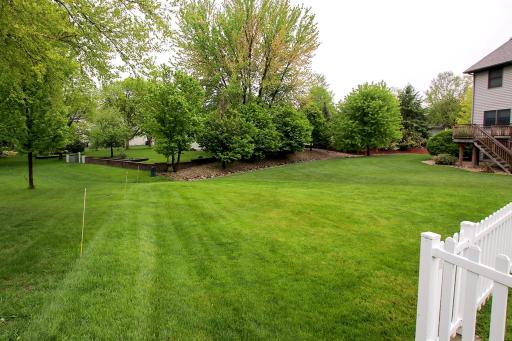 The yard is pie shaped and comes to a point in the back.