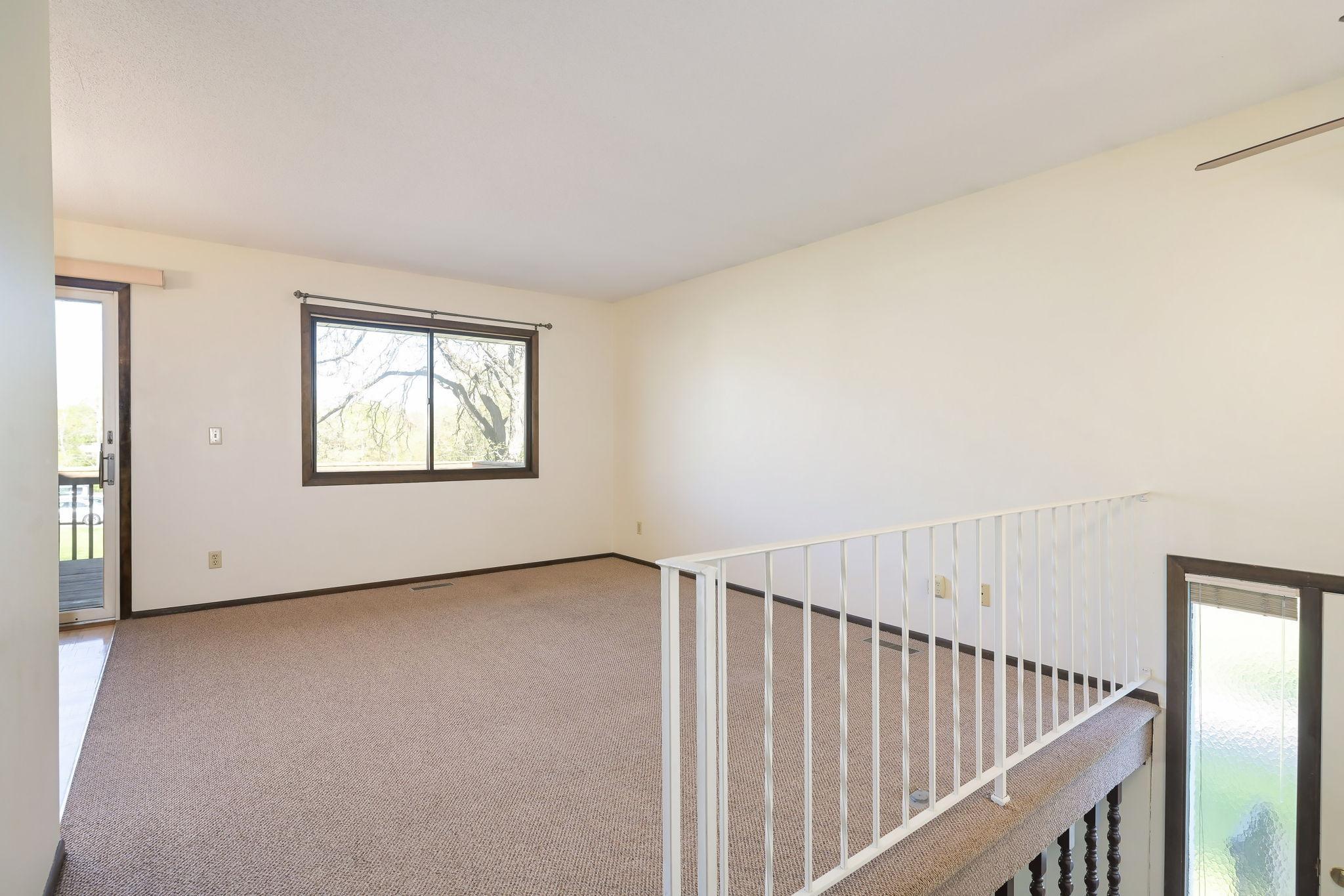 Upper level has sunny living room~
