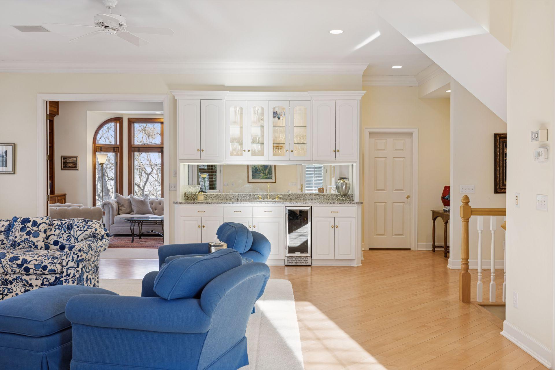 A built-in wet bar with glass-front cabinetry and a beverage refrigerator adds both style and function.