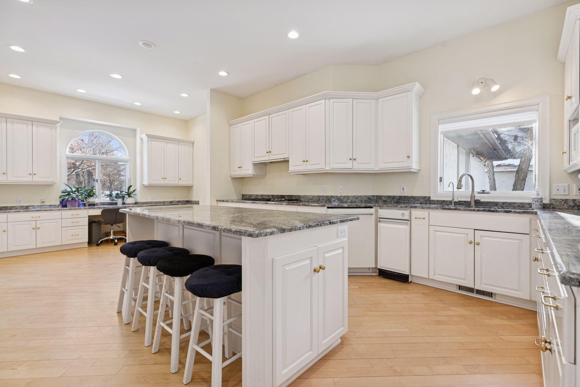 The expansive kitchen offers generous granite counter space and multiple work zones, making it easy to cook, prep, and host all at once
