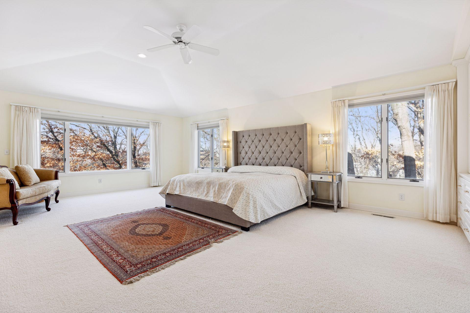 An entire level dedicated to the primary bedroom suite feels open and airy, with room to truly spread out and picture windows on two walls that bring in treetop views and beautiful natural light