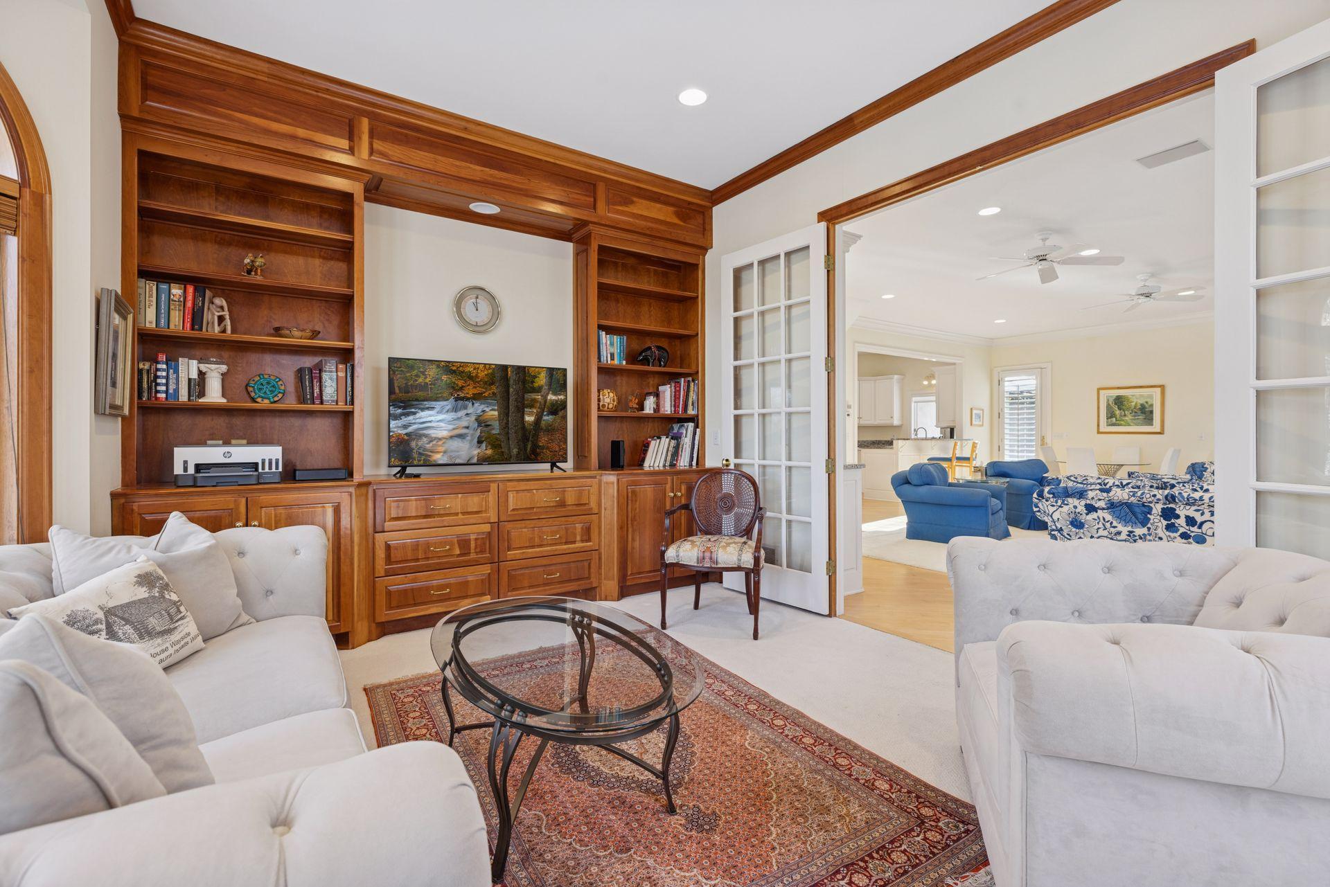 Located just off the living room and separated by double glass French doors, this space easily adapts as a family room, den, or home office depending on your needs