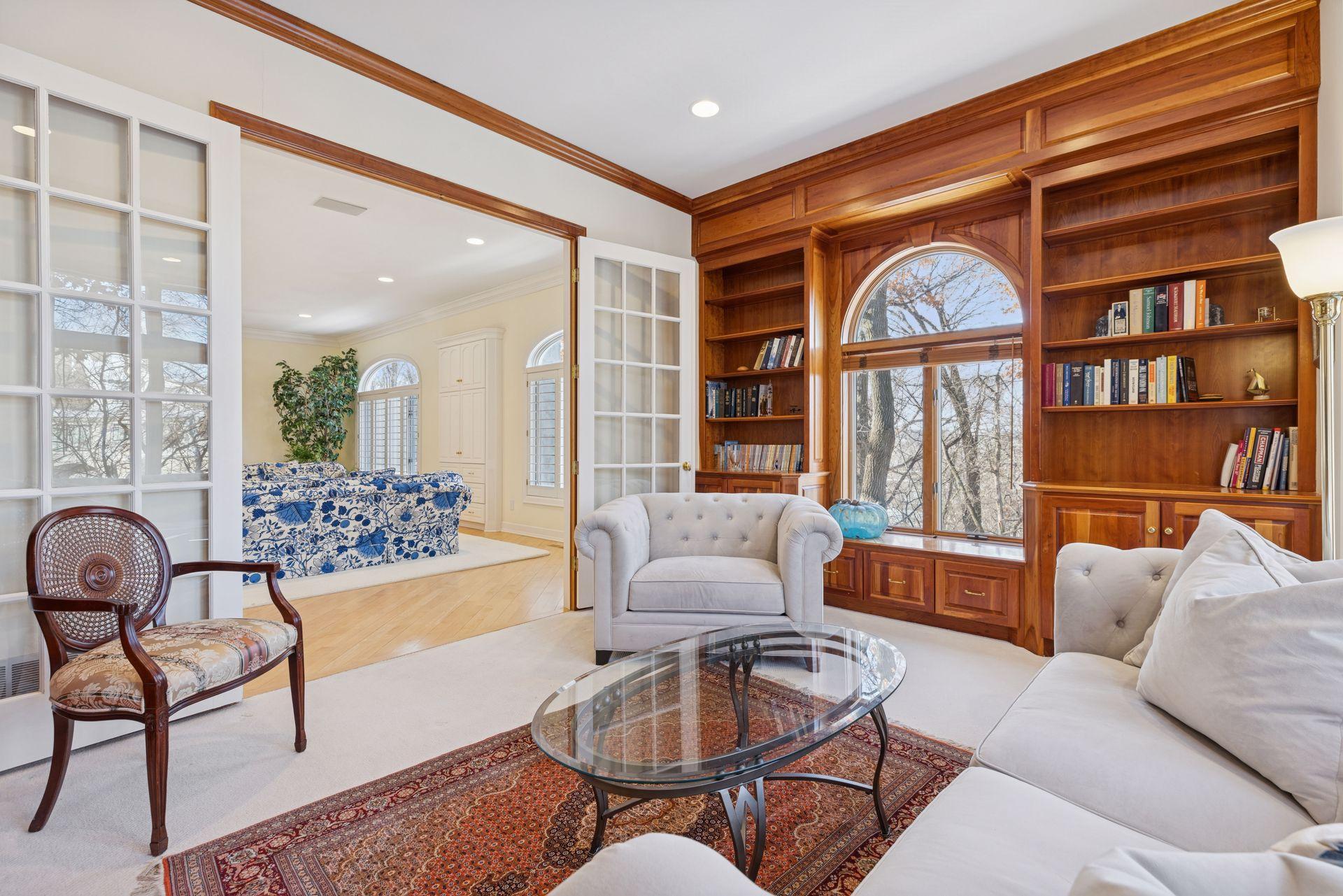 Two walls of custom bookcases and cabinetry add both function and warmth, making this room as practical as it is inviting