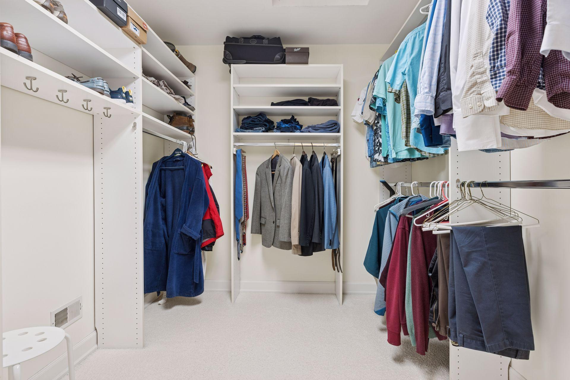 The primary suite features two private bathrooms, each with a spacious walk-in closet, offering potential space for a future stack-able washer and dryer if desired