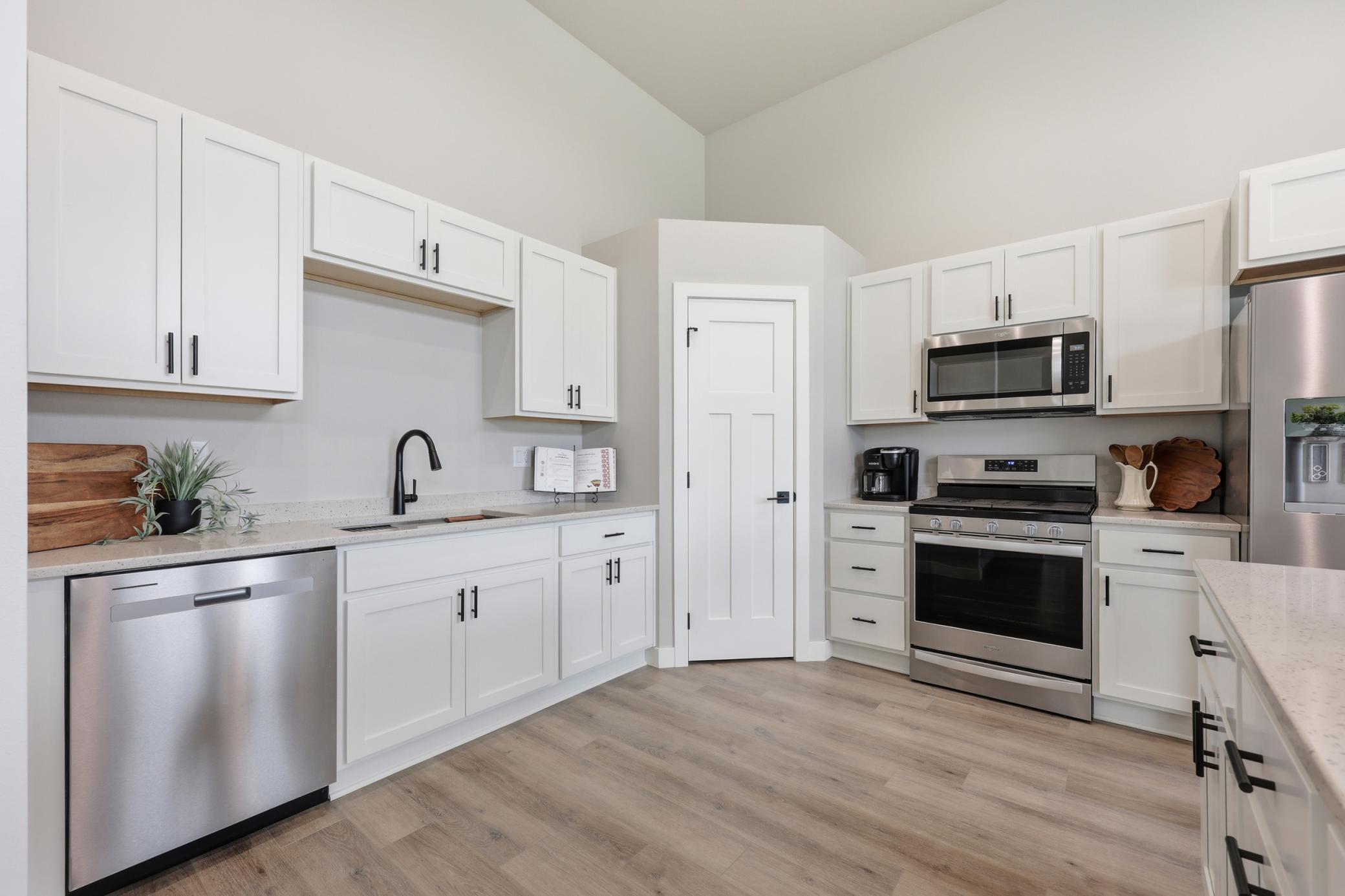 Kitchen Upgrades include: 5 Burner Gas Range, Exterior Vented Microwave, Quartz Counter Tops, & Soft Close Doors and Drawers