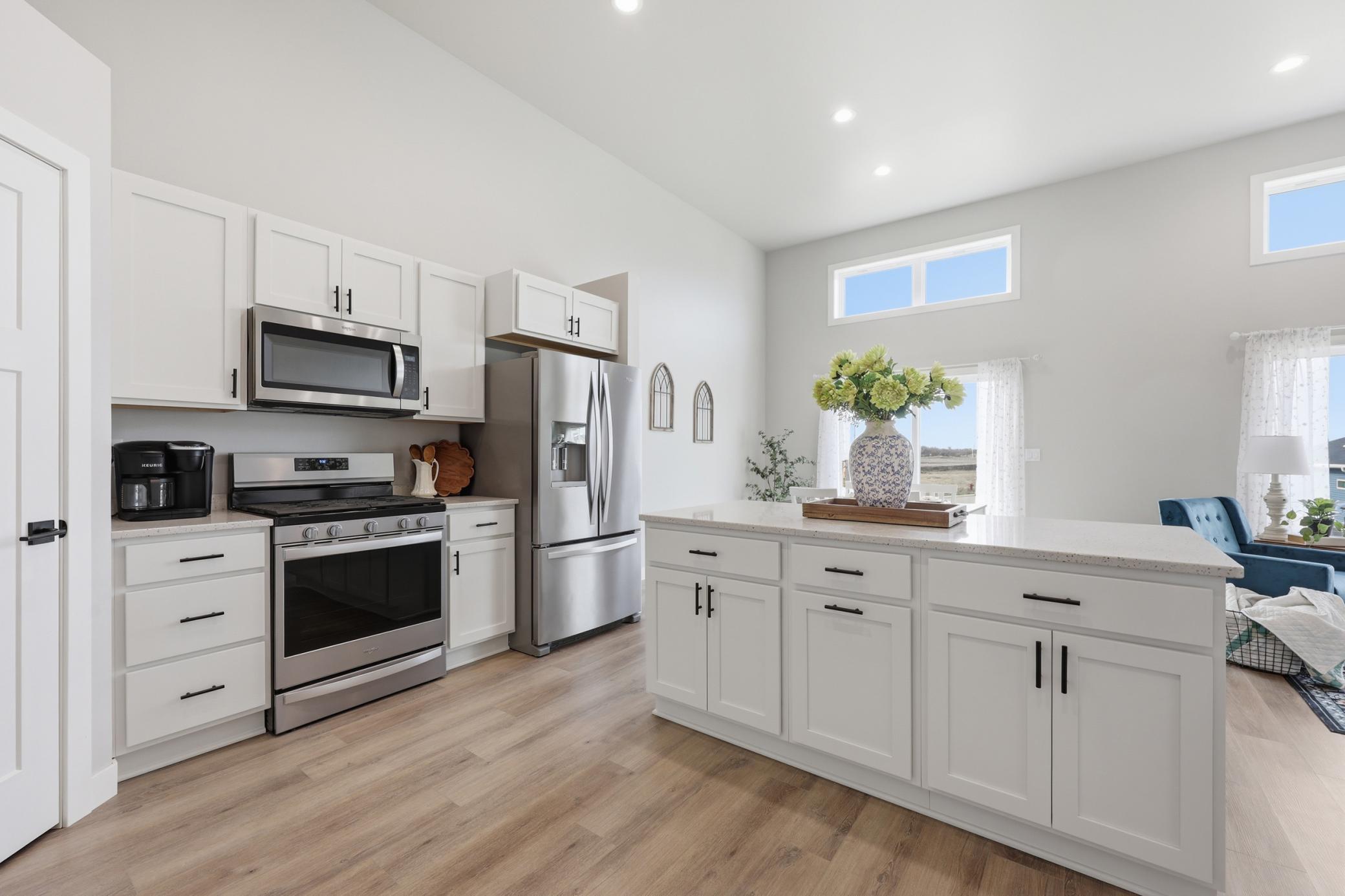 Kitchen Upgrades include: 5 Burner Gas Range, Exterior Vented Microwave, Quartz Counter Tops, & Soft Close Doors and Drawers