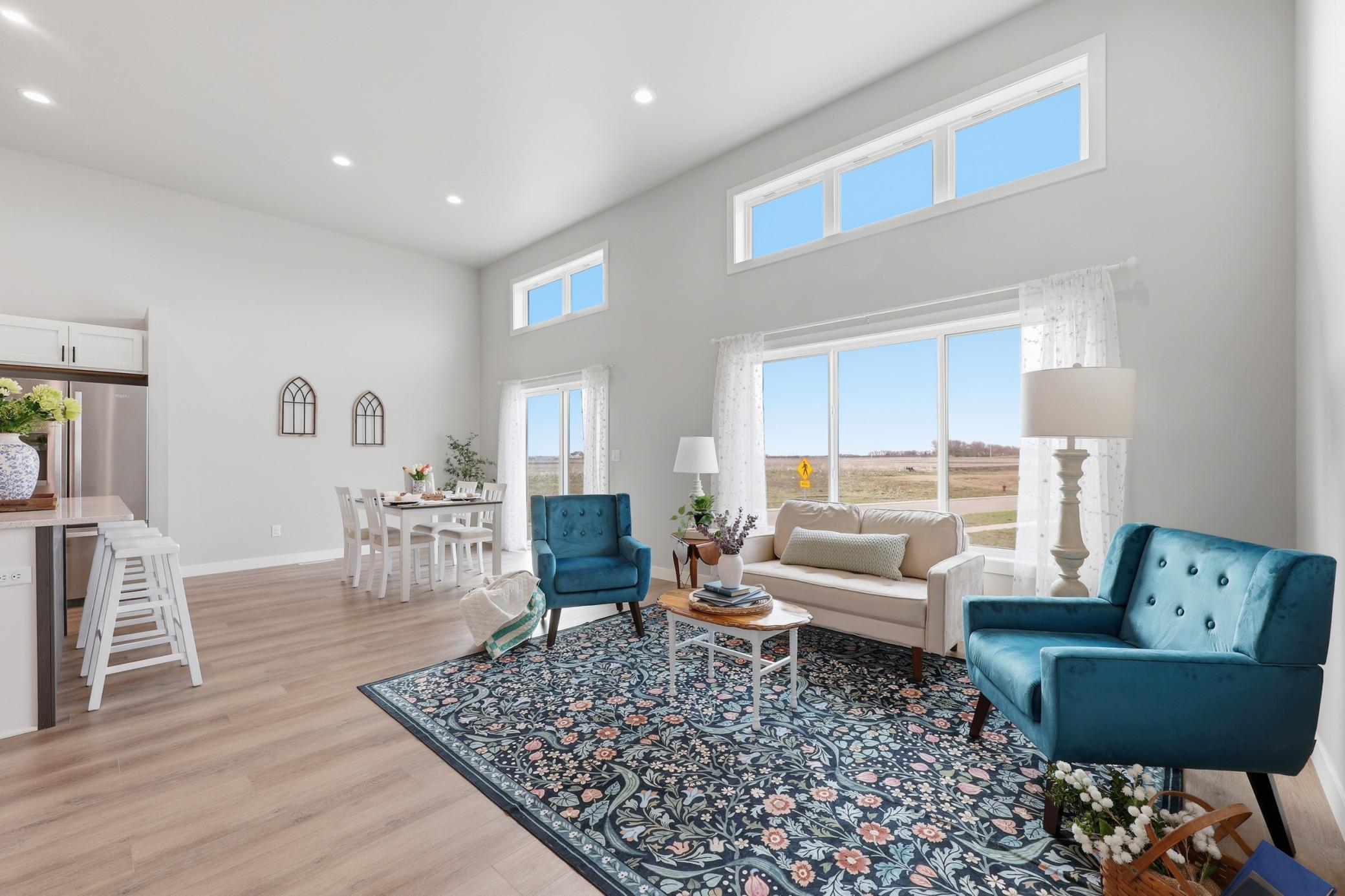 Floor to Ceiling Windows Flood the main Floor with Natural Light and Beautiful Laminate Vinyl Plank Floor Provide Durability Style
