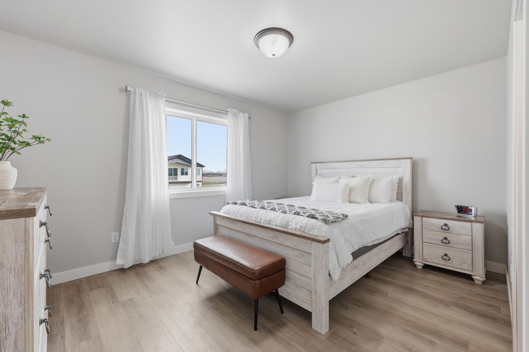 Primary Bedroom with Laminate Vinyl Plank Floors, Private Full Bath and Walk-In Closet