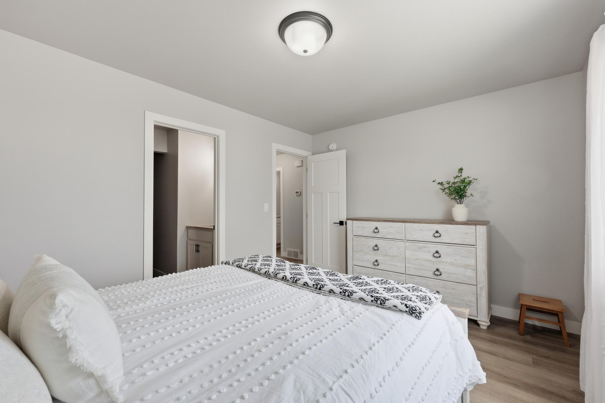 Primary Bedroom with Laminate Vinyl Plank Floors, Private Full Bath and Walk-In Closet