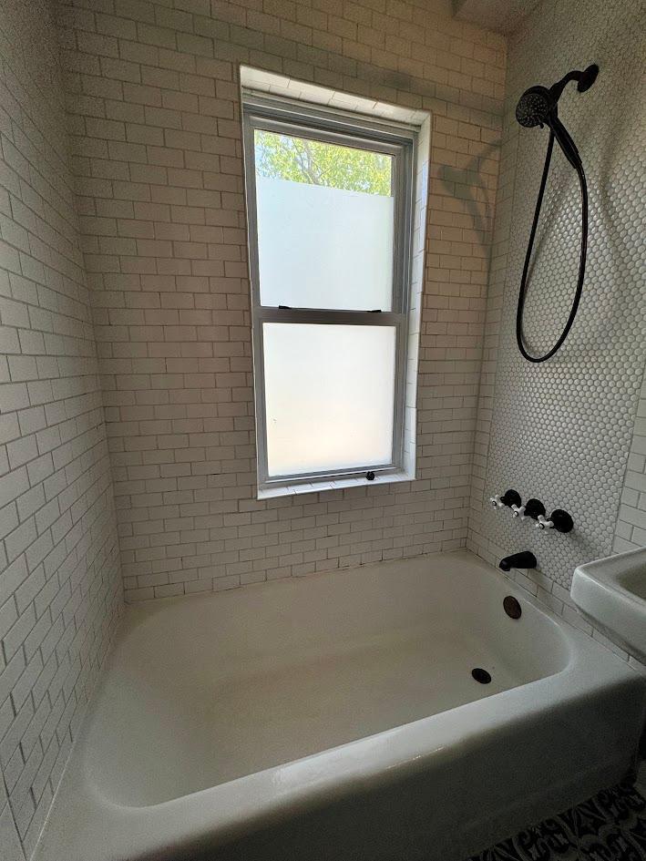 Main Floor Full Bathroom tiled shower