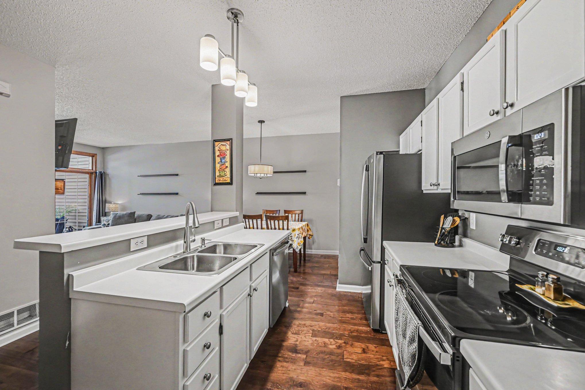Modern Kitchen with pendant lights over island.