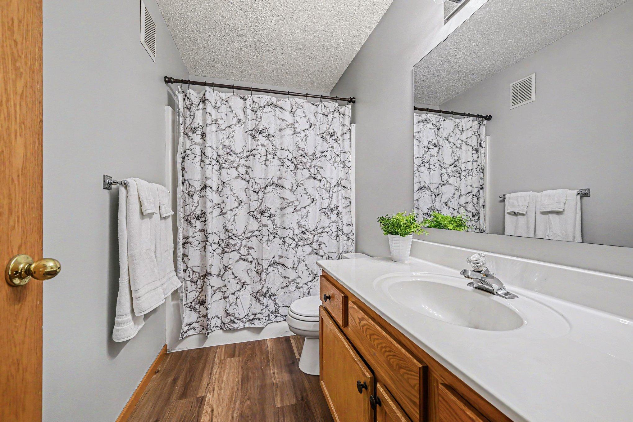 Upper Full Bath features new plank vinyl flooring