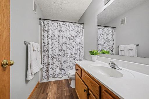 Upper Full Bath features new plank vinyl flooring