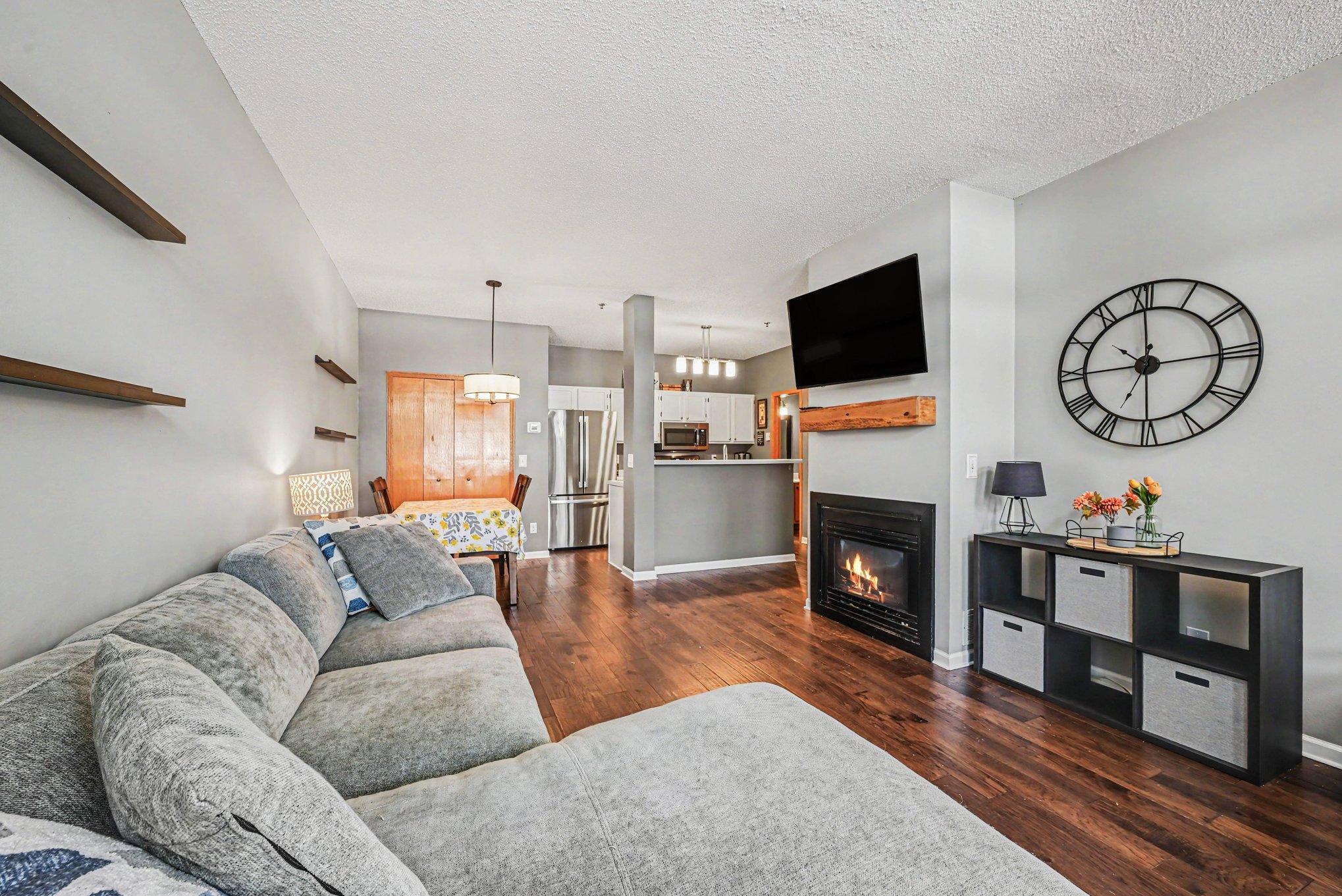 Main Floor features an open floor concept with engineered wood flooring throughtout the main level & a gas fireplace