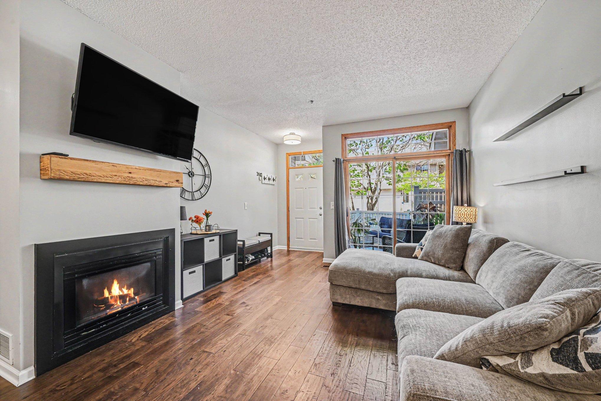 Living room patio doors with upper transom windows that fills the room with natural lighting.