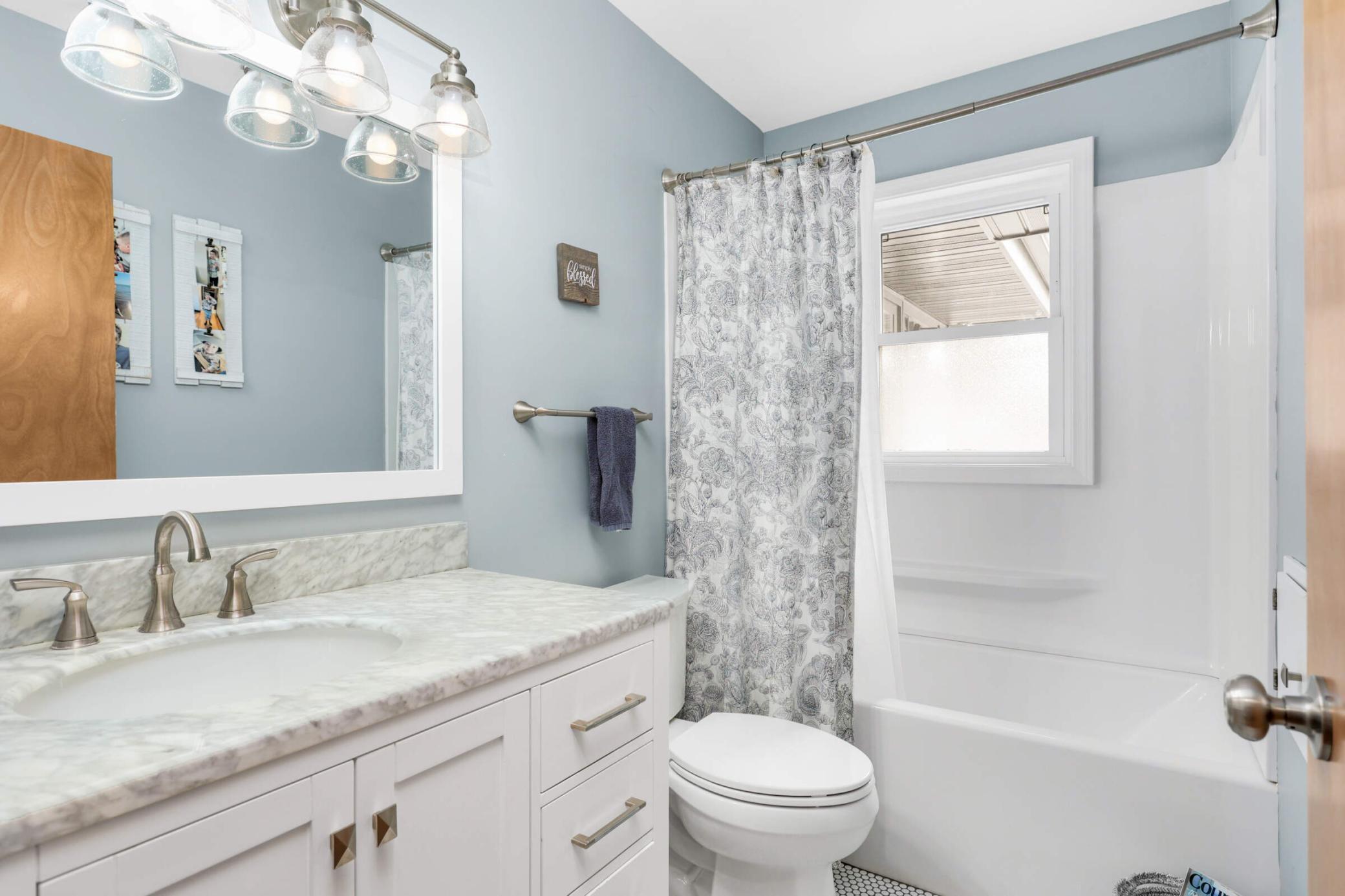 Updated bathroom with modern finishes, offering a clean, refreshed feel and move-in-ready convenience.