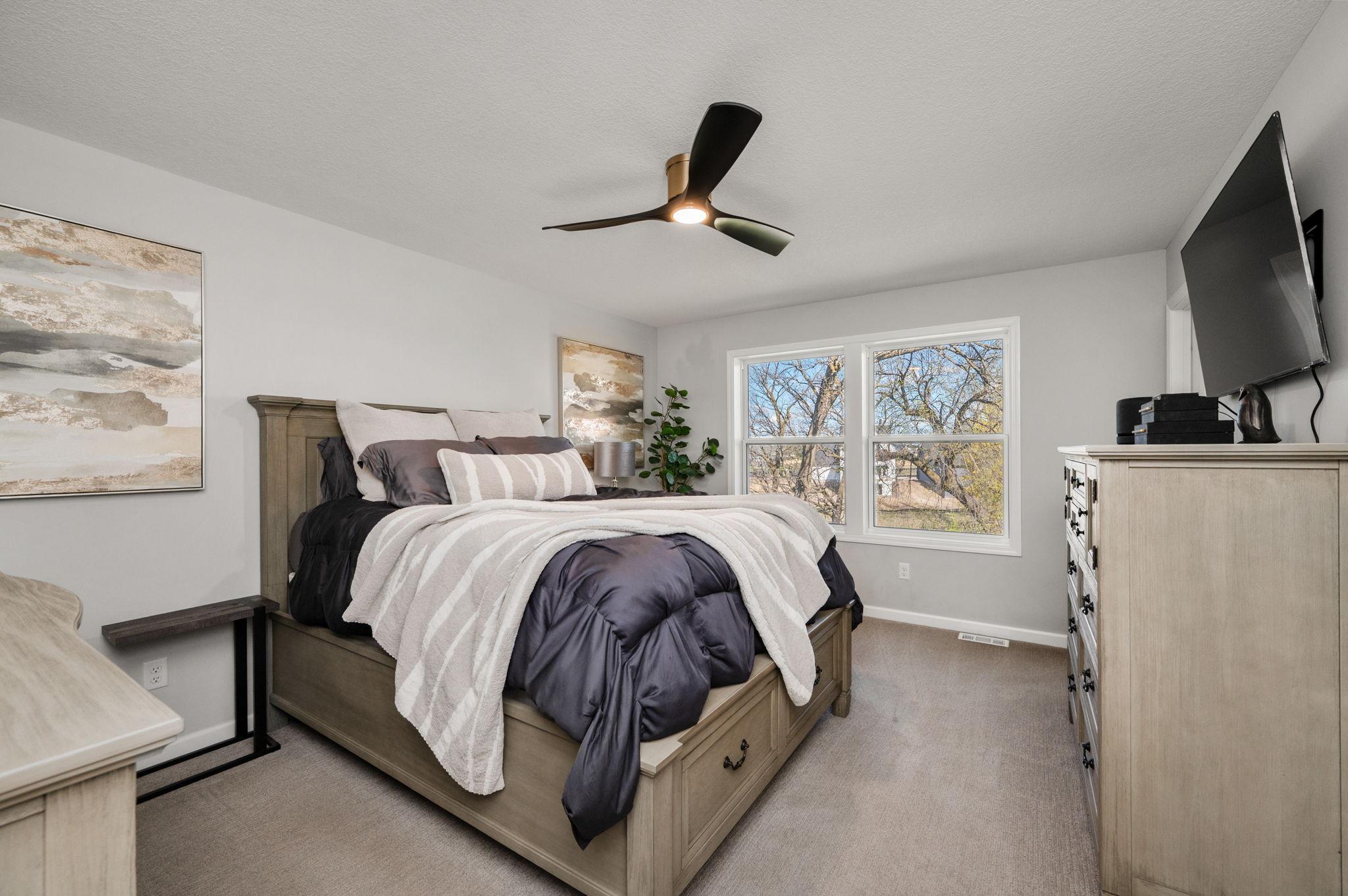 A luxurious Owner’s Suite with a walk-in shower with custom tile/glass door, double vanity, and a spacious walk-in closet
