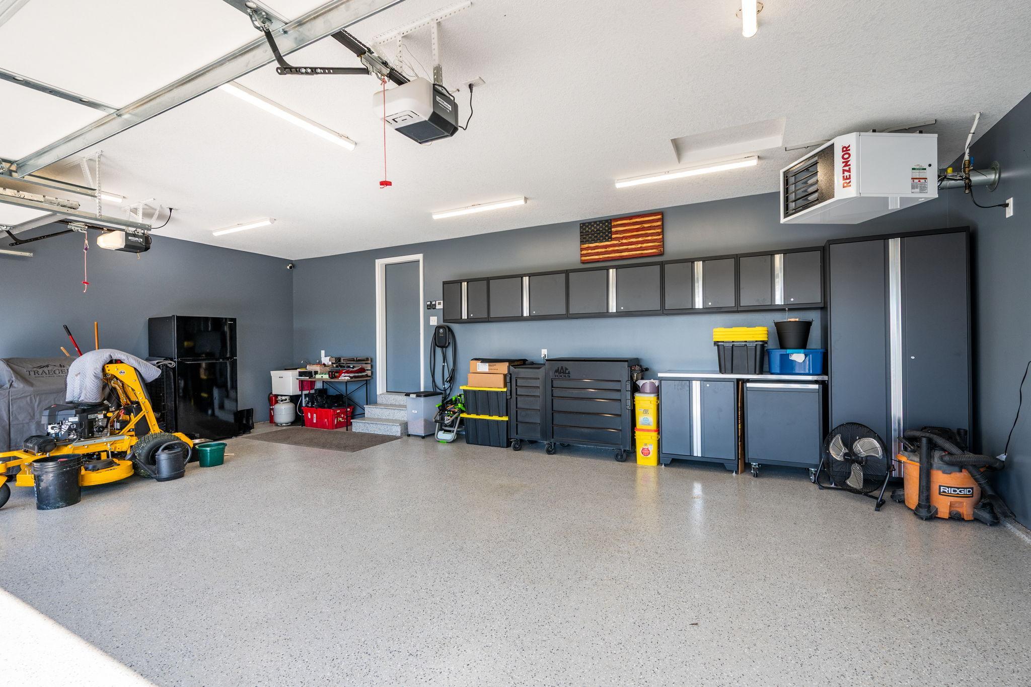 Garage Lover’s Dream: Fully insulated and heated 3-car garage with epoxy floors, built-in cabinets, knock-down ceilings, and an EV-ready charging outlet