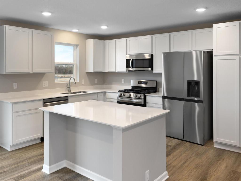Kitchen. Photo taken of another home with similar plan and finishes. Photos and renderings may not depict actual plan, materials, & finishes may vary. All measurements are approximate.