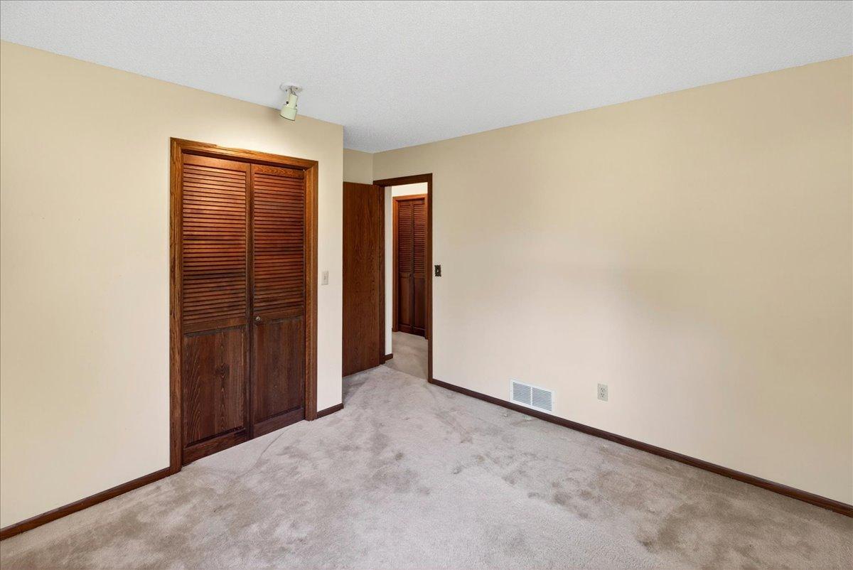 Additional bedroom with large closet space and neutral décor ready for your personal touch.