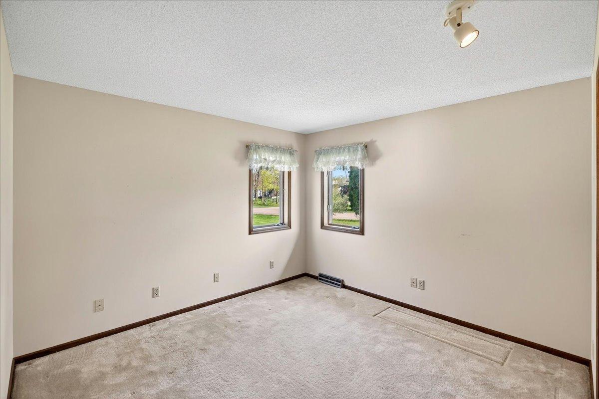 Additional bedroom with large closet space and neutral décor ready for your personal touch.