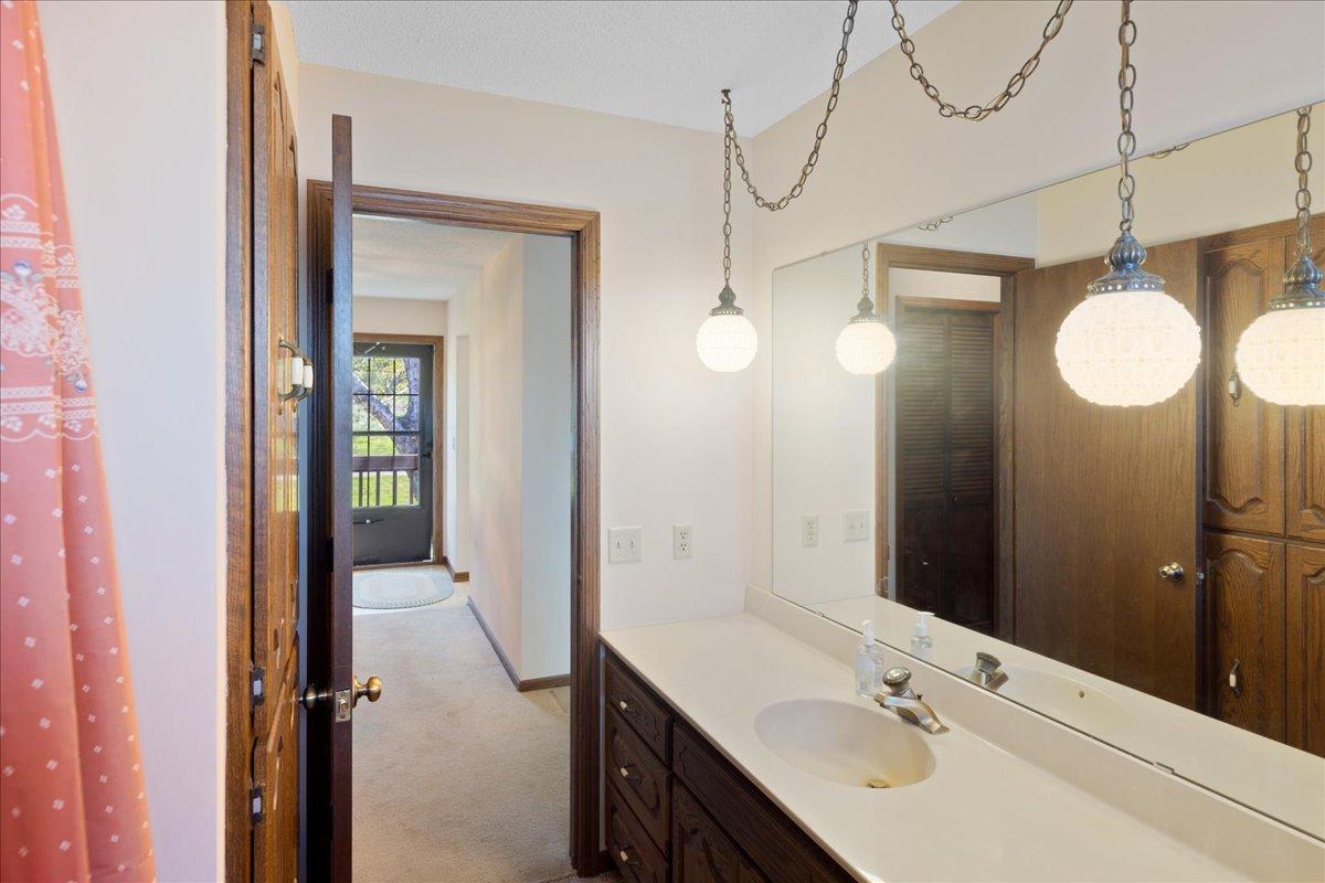 Spacious main level full bathroom with oversized vanity, abundant storage, and updated fixtures.