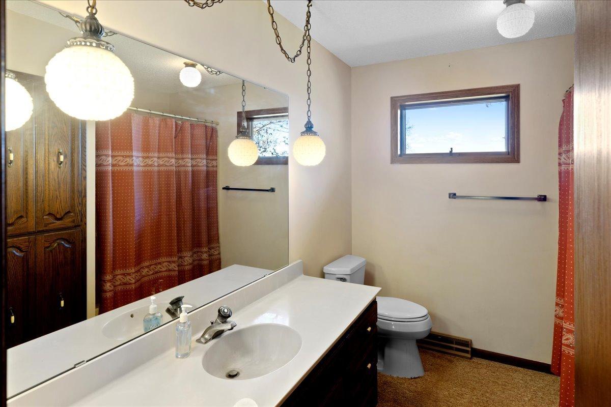 Full bathroom with large vanity area and convenient access to the main level bedrooms.