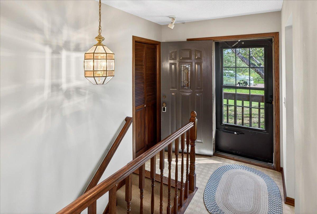 Bright entryway with split-level foyer layout and convenient access to both levels of the home.