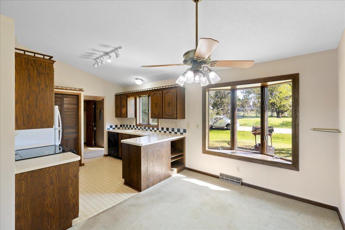 Spacious dining area filled with natural light and open flow into the kitchen.