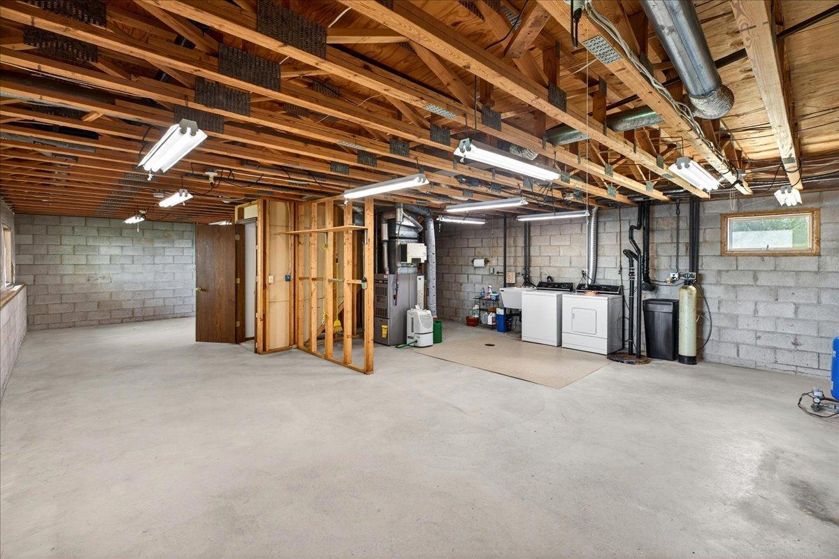 Large unfinished lower level with endless potential for future family room, bedrooms, recreation space, or workshop area.