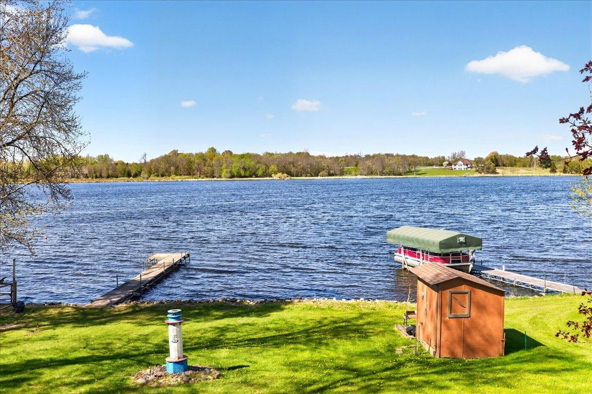 The dock to the left is included with the property, along with the lakeside boat house perfect for storing fishing poles, life jackets, lawn chairs, and other lake essentials. Enjoy beautiful lake views, dock access, and excellent shoreline!