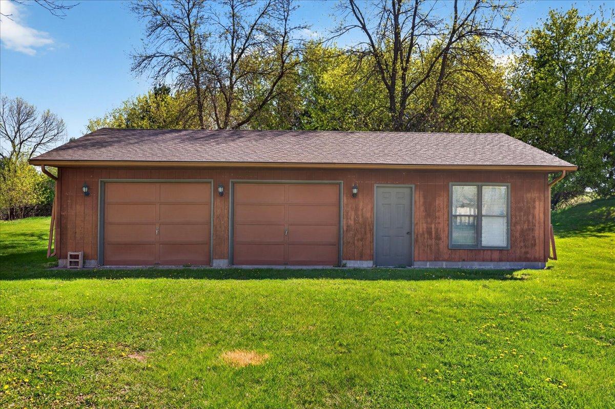 Detached 3-car garage with multiple overhead doors and approximately 960 sq ft of storage or workspace flexibility.