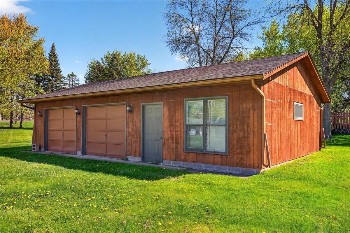 Detached garage with multiple overhead doors and excellent storage or workspace flexibility.