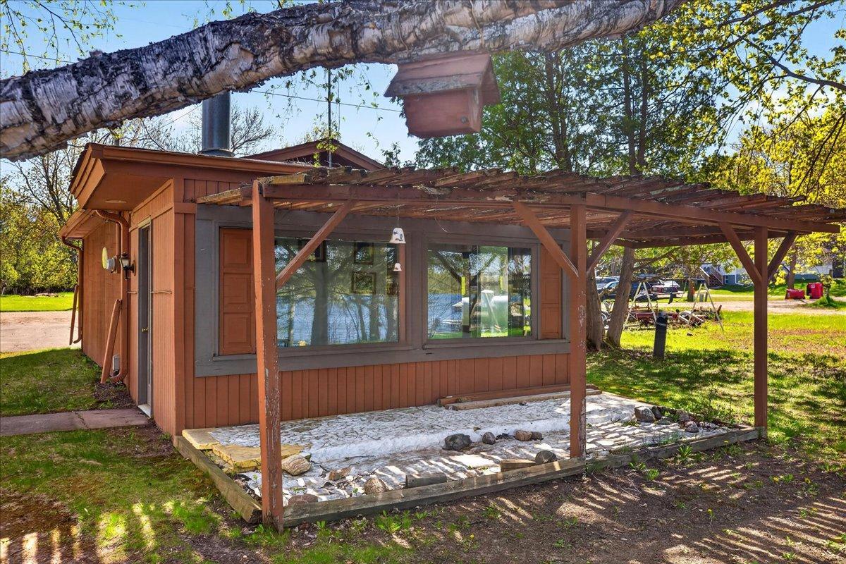 Cozy lakeside bonus area with pergola-covered patio area and relaxing water views.