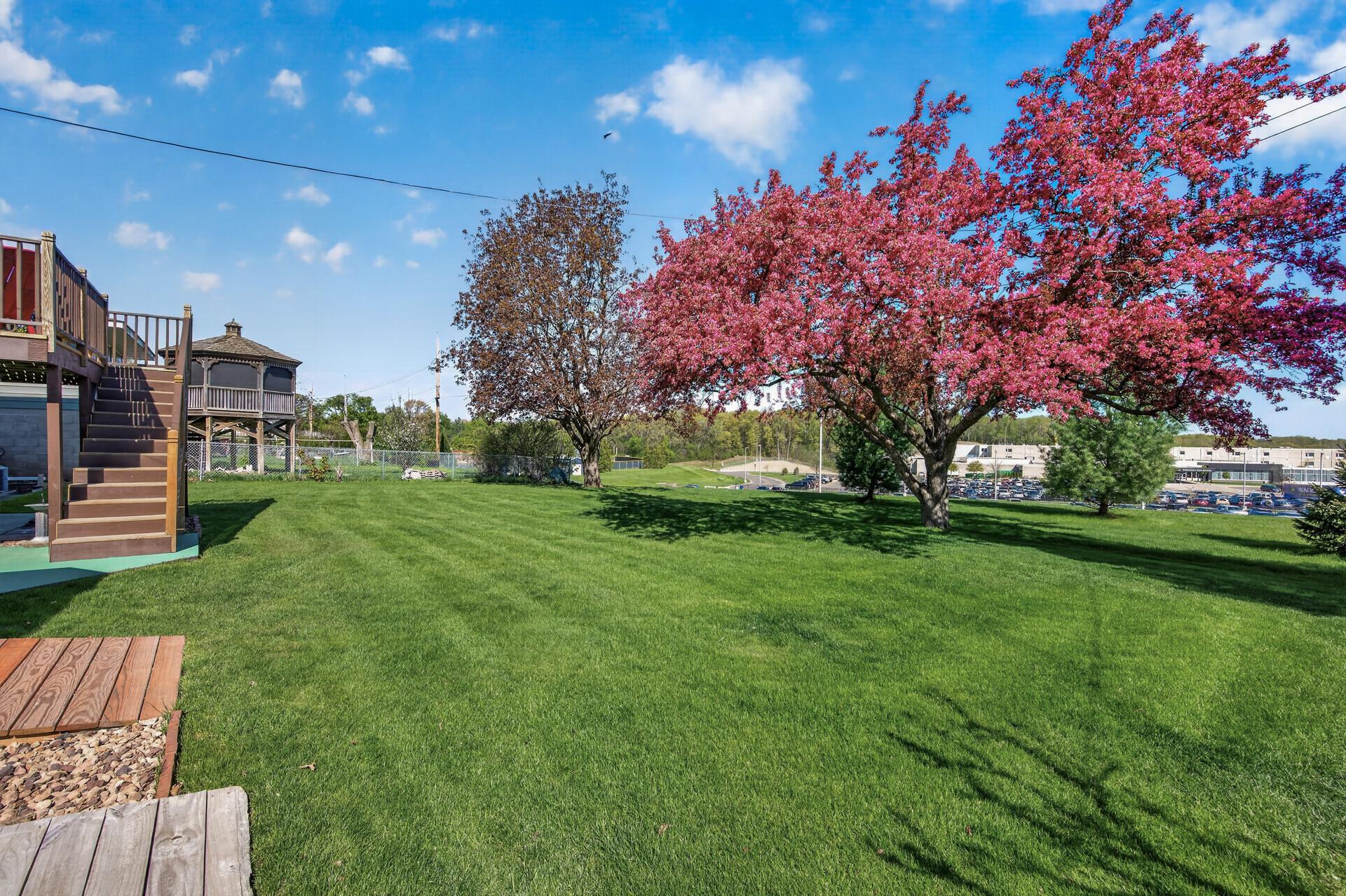 Beautifully maintained yard has in-ground sprinkler system