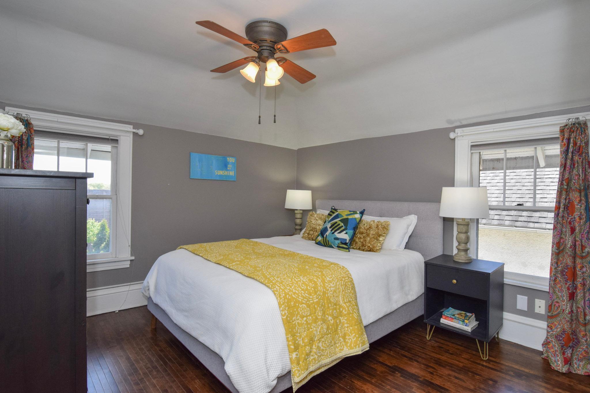 Primary bedroom with original hardwood floors & 2 windows!